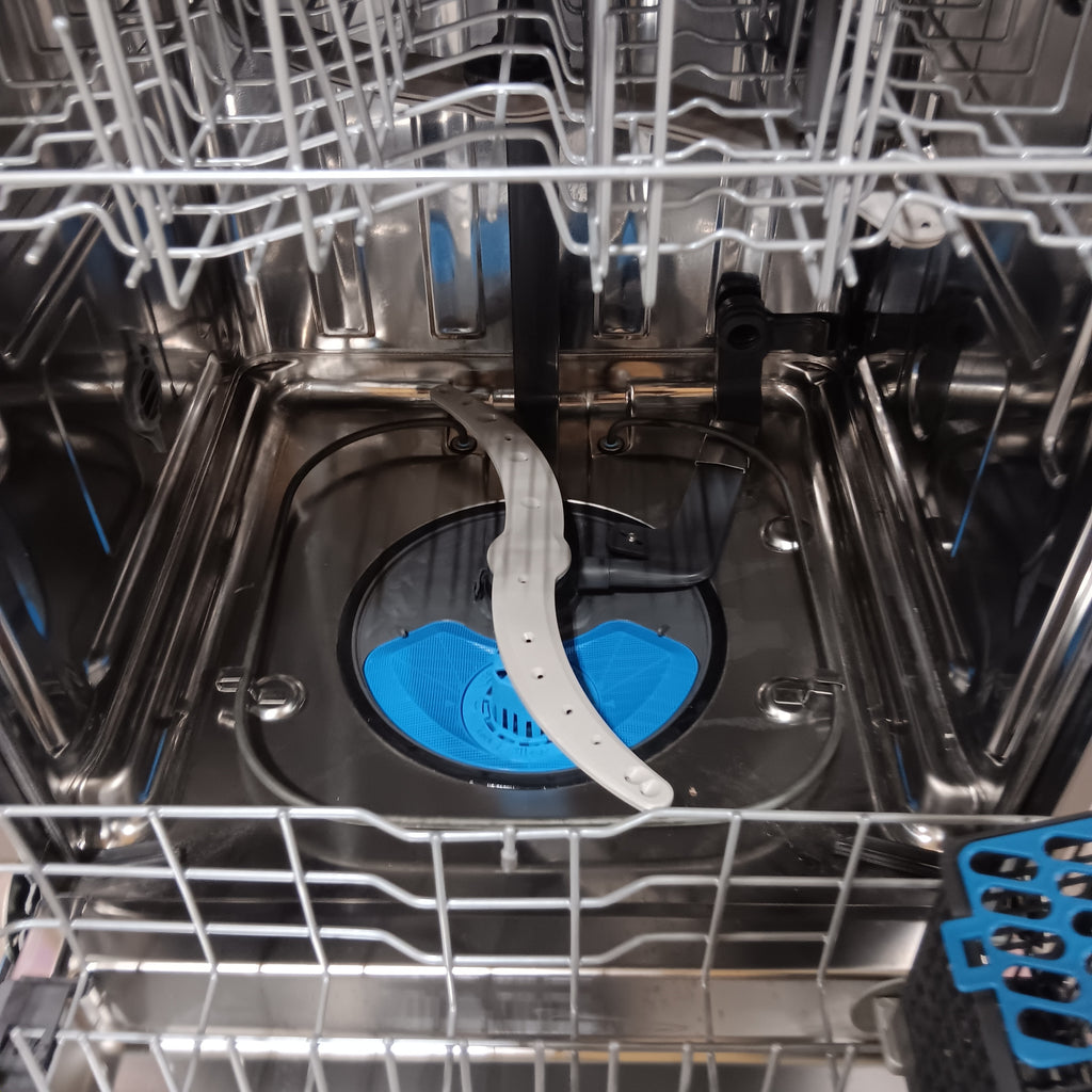 GE PDT715SYVFS Open dishwasher with blue filter and silver racks