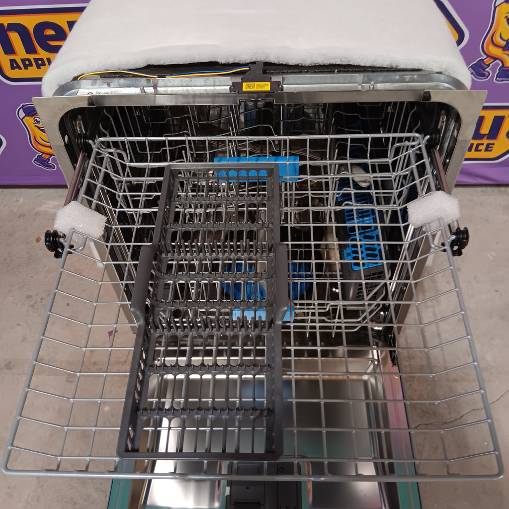 GE PDT715SYVFS Open dishwasher with a silver rack inside, showing the interior and surrounding area.