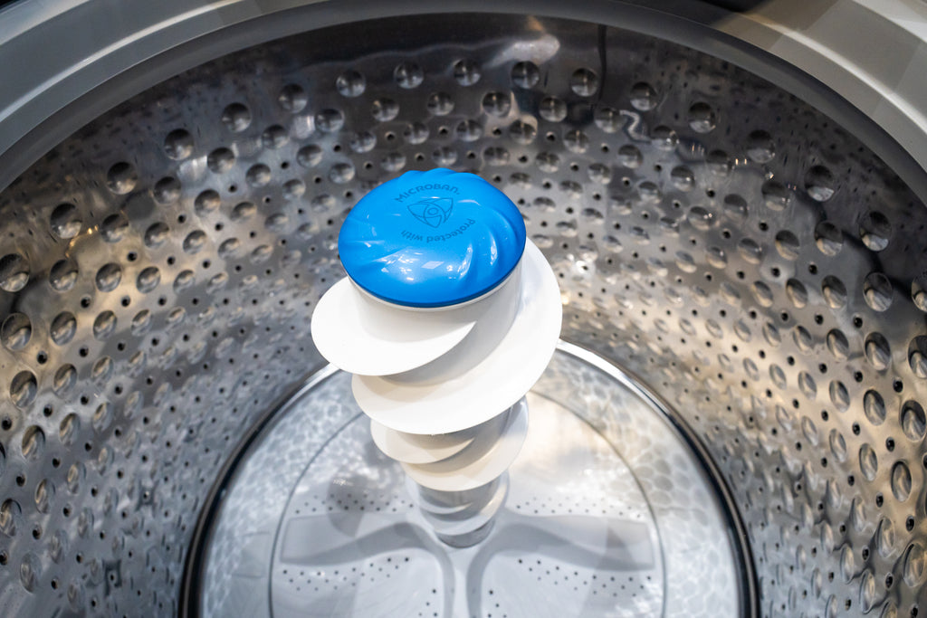 GE PTW605BPRDG Clothes dryer drum with a blue and white dryer sheet inside