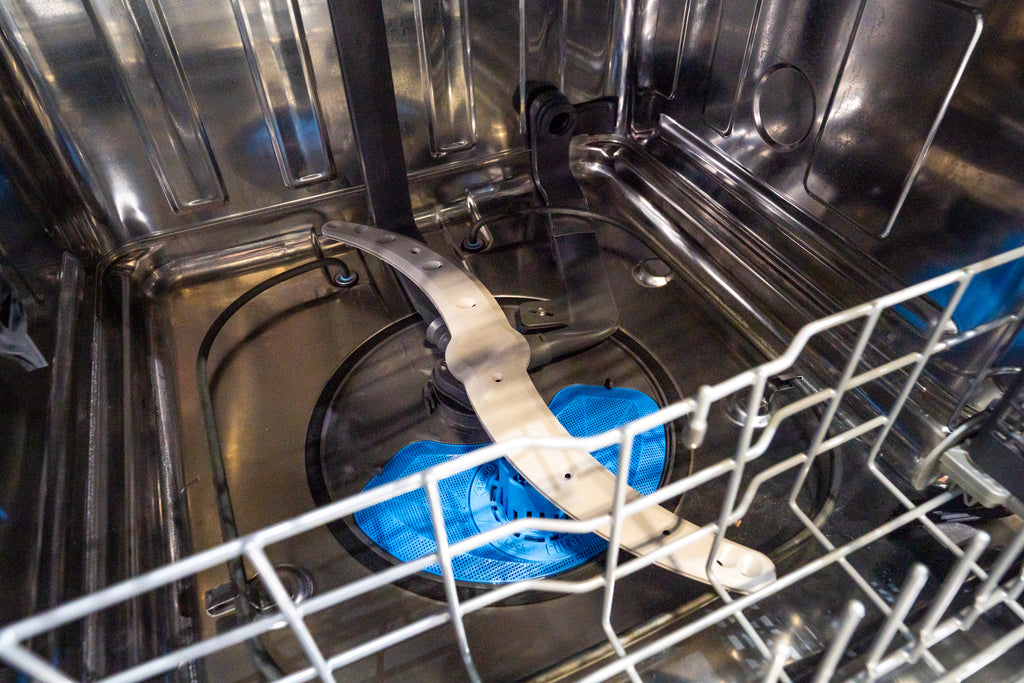 GE PDT715SYVFS Open dishwasher with a blue sponge inside the rack