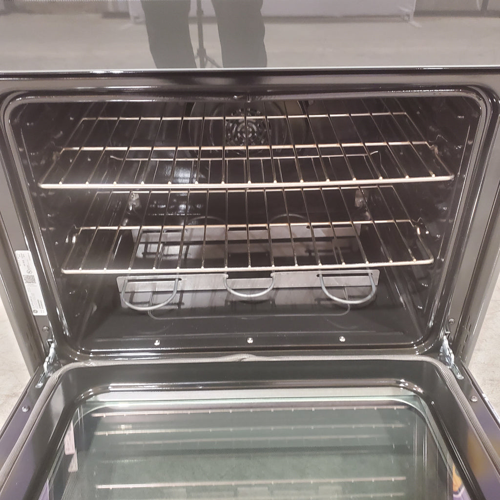 Open GE Free-Standing 30" Electric Double Oven Convection Range JBS86SPSS with racks inside, showing interior details.