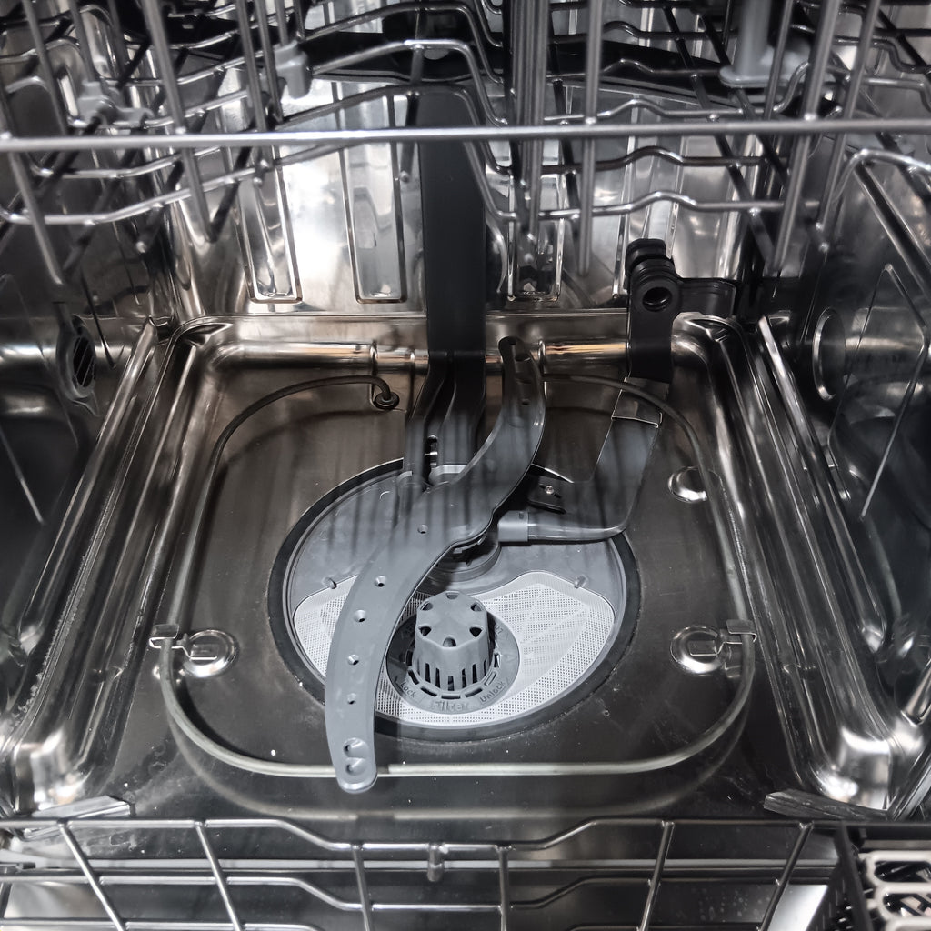 GE CDT858P3VD1 Close-up of a silver dishwasher interior with racks and spray arm.