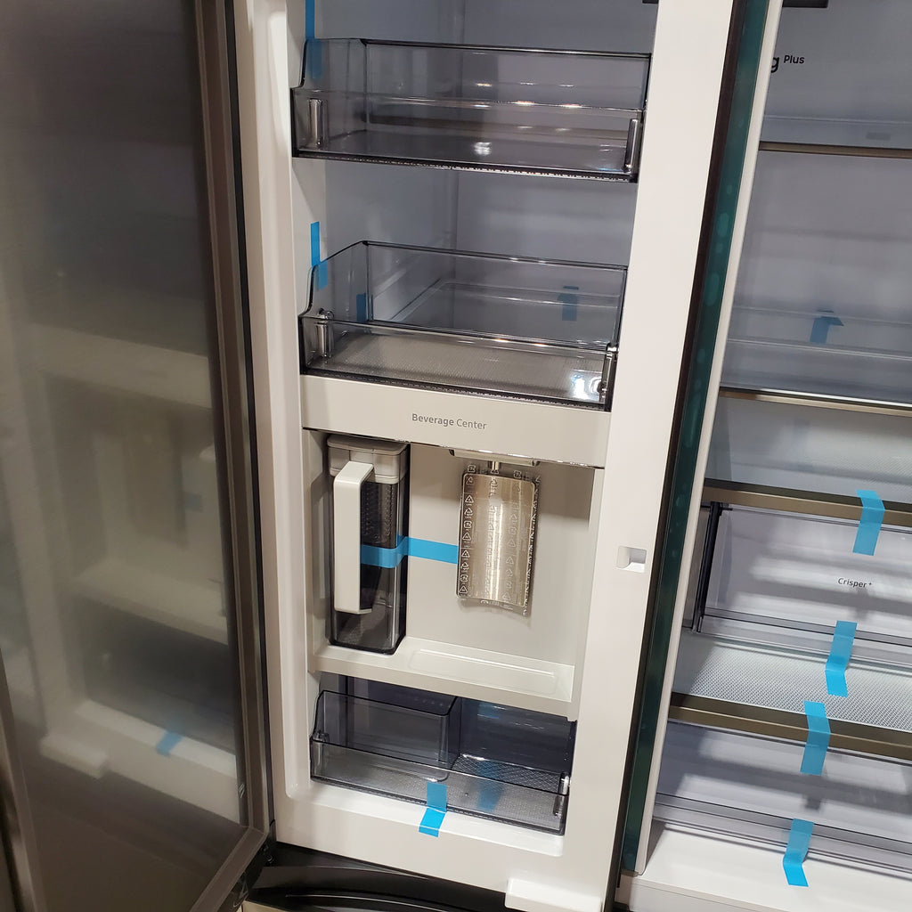 Close-up of a Samsung Bespoke 3-Door French Door RF30BB6600QL Refrigerator interior with blue tape on the shelves