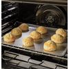 Baked biscuits on a baking sheet inside an GE Free-Standing 30" Electric Double Oven Convection Range JBS86SPSS 