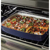 Baked dish with vegetables and cheese in a blue baking dish inside an GE Free-Standing 30" Electric Double Oven Convection Range JBS86SPSS 