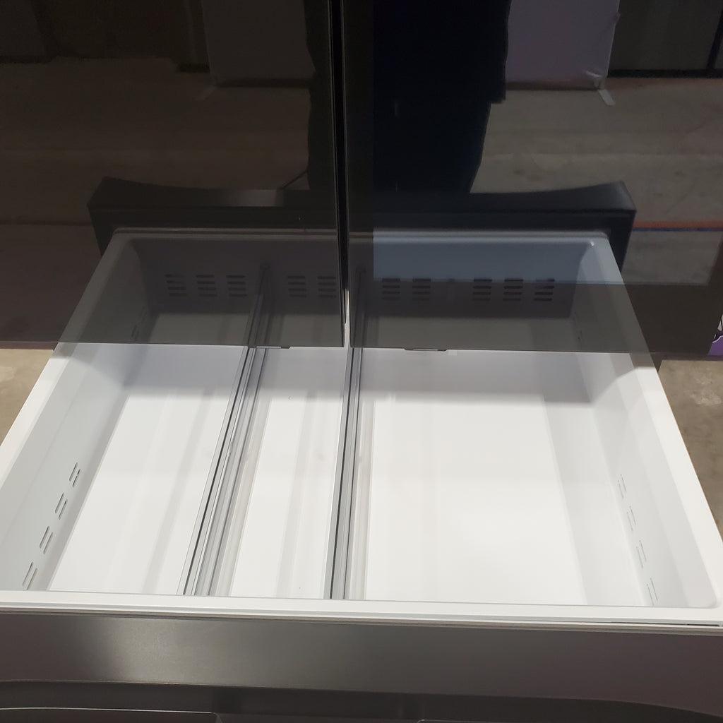 Open Samsung Bespoke RF90F29AECRAA 4-Door French Door Refrigerator with light on, showing interior shelves.