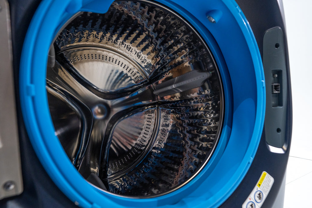 GE PFW870SPVRS Close-up of a washing machine drum with visible wear and tear.
