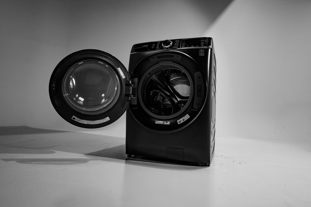 GE PFW870SPVRS Black washing machine with open door on a gray background