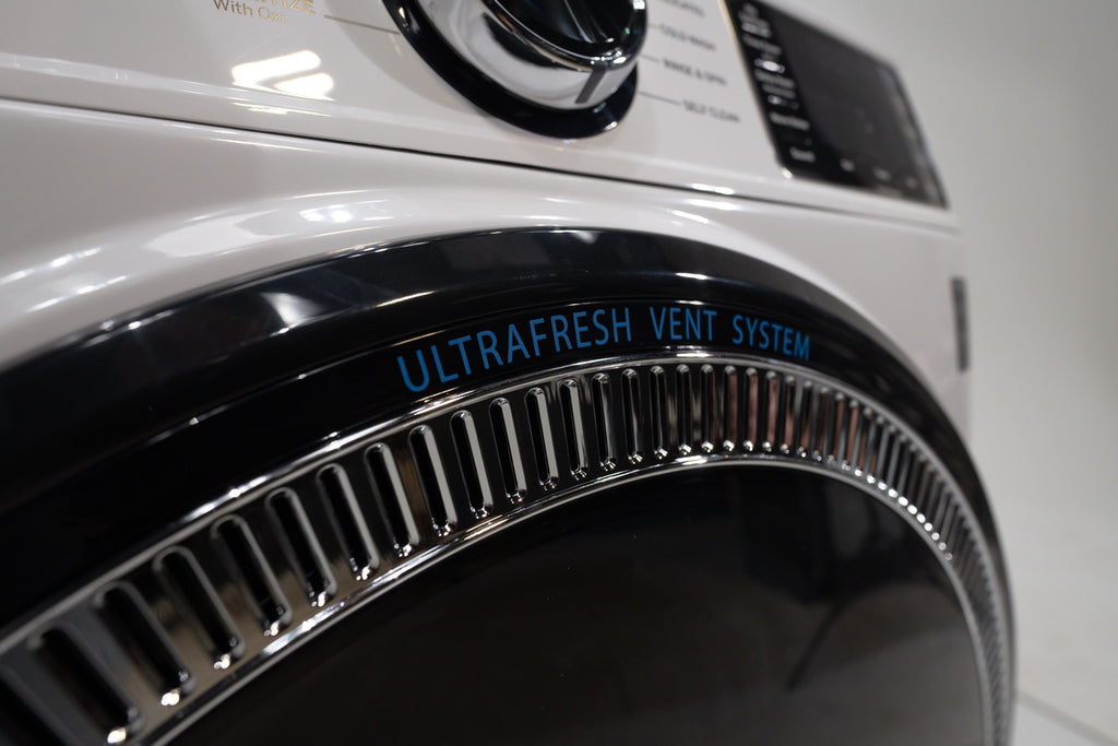 GE GFW550SSNWW Close-up of a dryer with 'UltraFresh Vent System' text on a white background