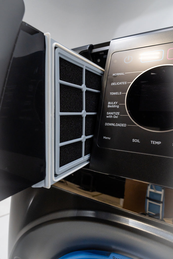 GE Profile PFQ97HSPVDS Washing machine with filter door open, showing a filter inside.