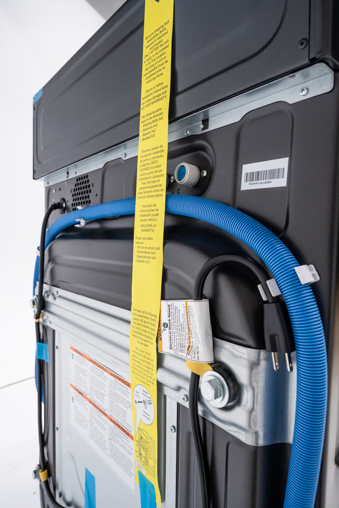 GE Profile PFQ97HSPVDS Back view of a piece of equipment with yellow and blue hoses and labels.