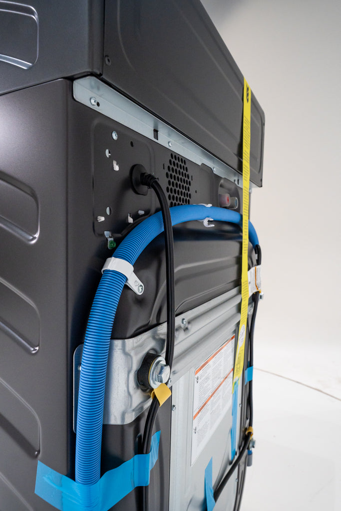 GE Profile PFQ97HSPVDS Back view of a piece of electronic equipment with blue hoses and yellow tape.