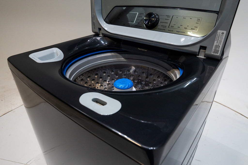 GE PTW605BPRDG Black washing machine with open door on a white floor