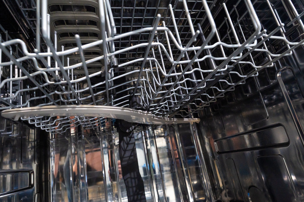 GE PDP795SYVFS Dishwasher interior with silver racks and a dark background