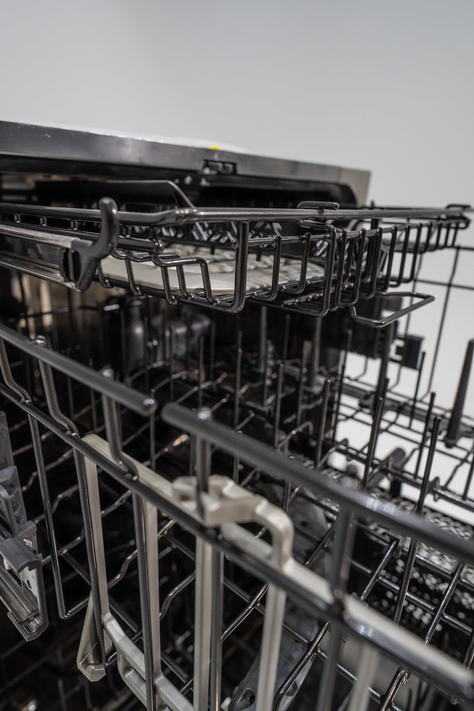 GE CDT858P3VD1 Open dishwasher with racks and interior view on a light gray background