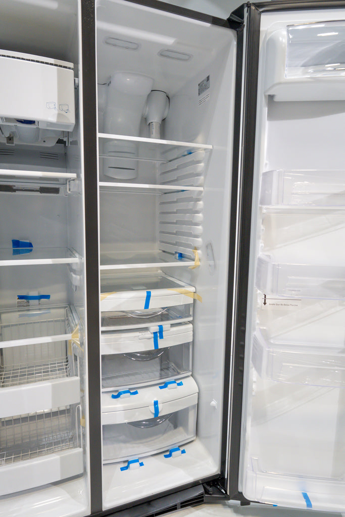 GE GSS25IYN Empty refrigerator with shelves and doors open