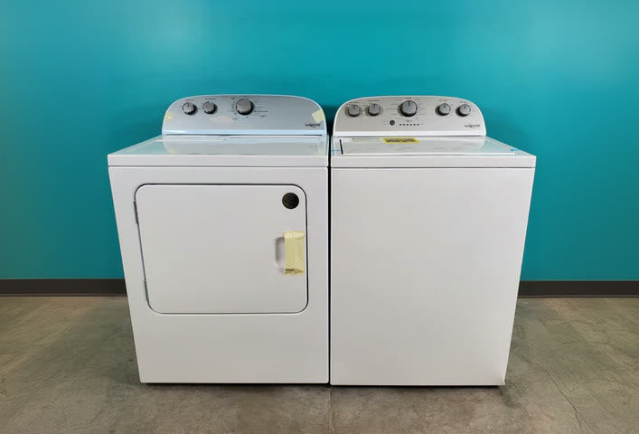 A white washer and dryer pair on the Neu Appliance Outlet showroom floor